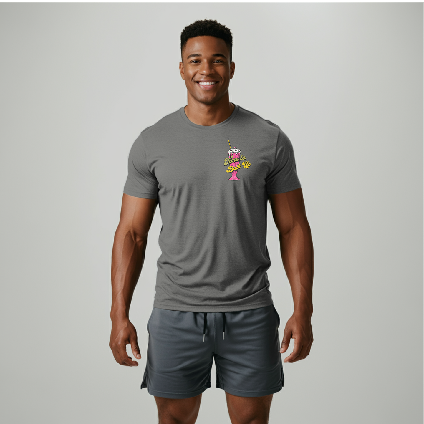 Grey

Model proudly wearing the Wildset 'Time to Bulk Up' shirt, a vibrant and eye-catching piece of fitness apparel inspired by leading brands like Gymshark and Fabletics. This stylish workout shirt features a playful design with an ice cream cone graphic on the front, reflecting a fun approach to fitness and bodybuilding. Perfect for those looking to add a bit of personality to their gym attire, this shirt is ideal for bodybuilders, powerlifters, and fitness enthusiasts. Gymshark and Fabletics